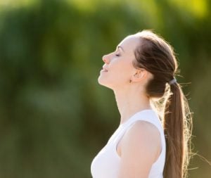 woman breathing in fresh air